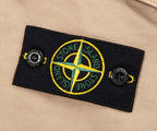 Stone Island patch on a beige background