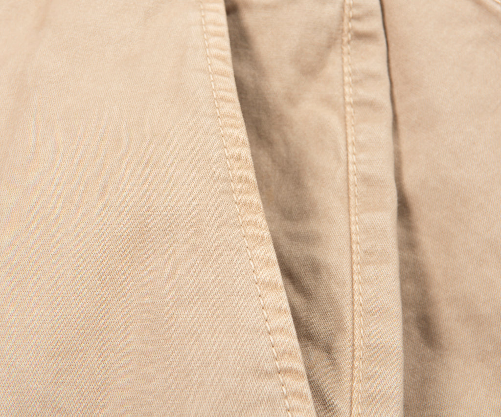 Close-up of beige fabric with a visible seam