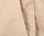 Close-up of beige fabric with a visible seam