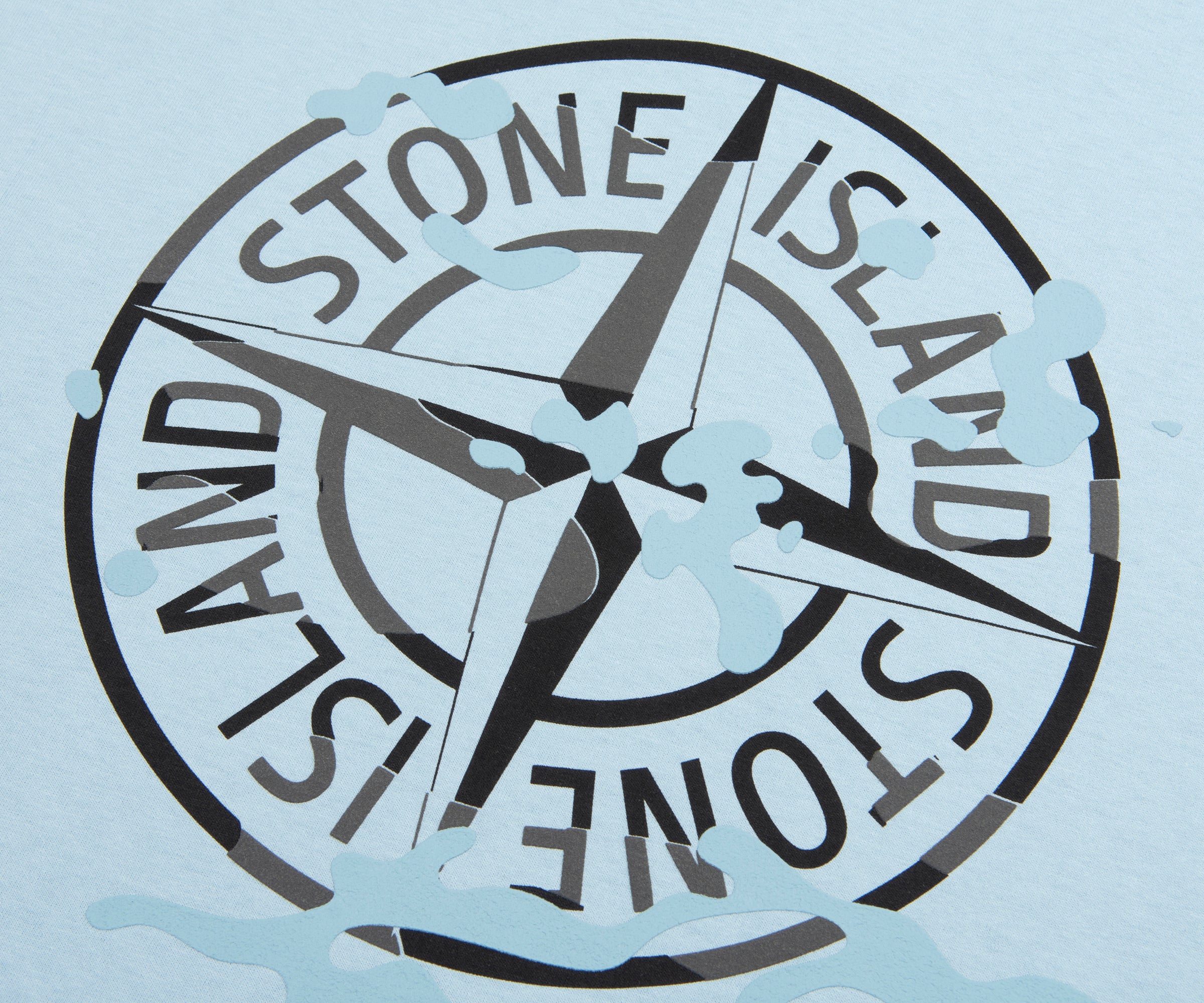 Stone Island logo with compass design on a light blue background