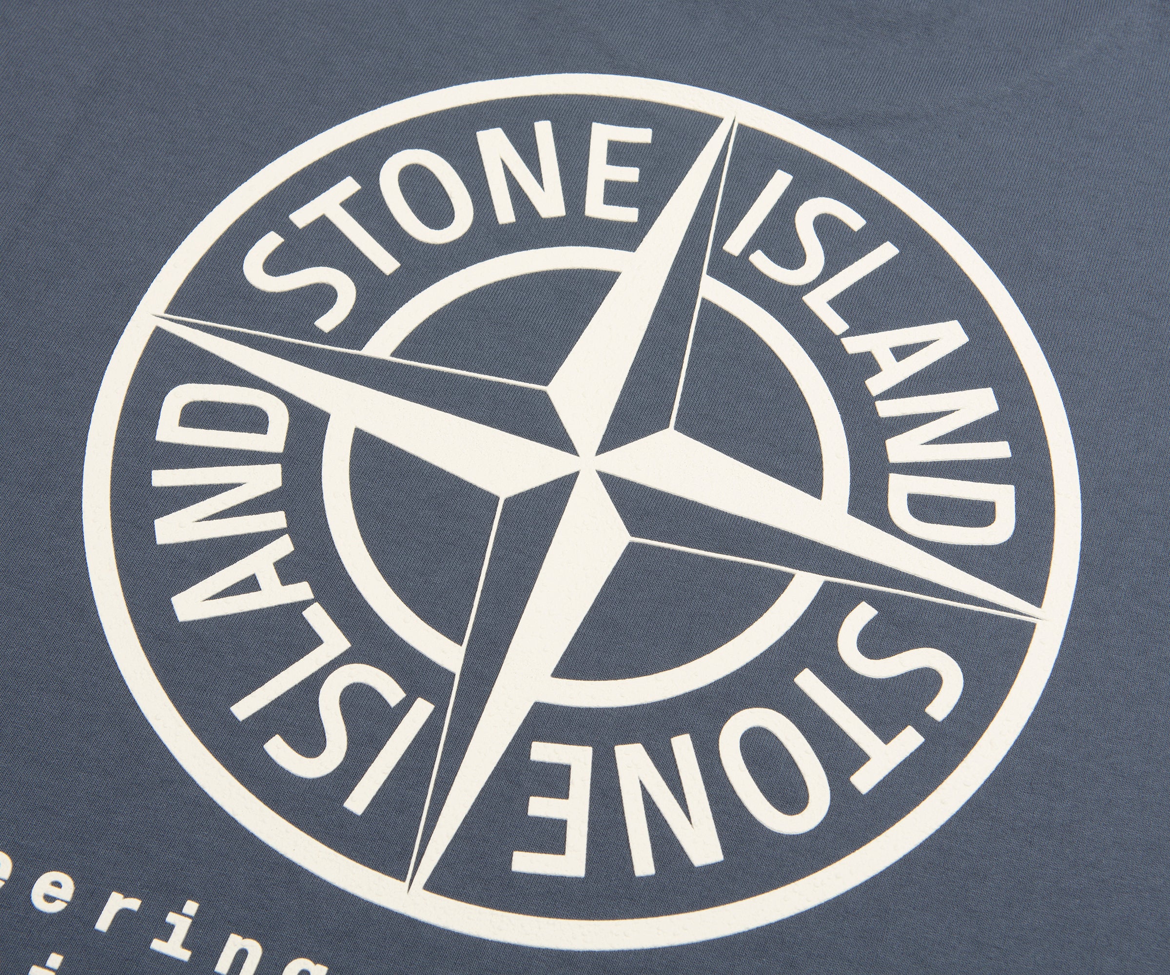 White Stone Island logo on a dark blue background