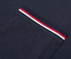 Navy blue sweater with a red and white striped trim on a dark background