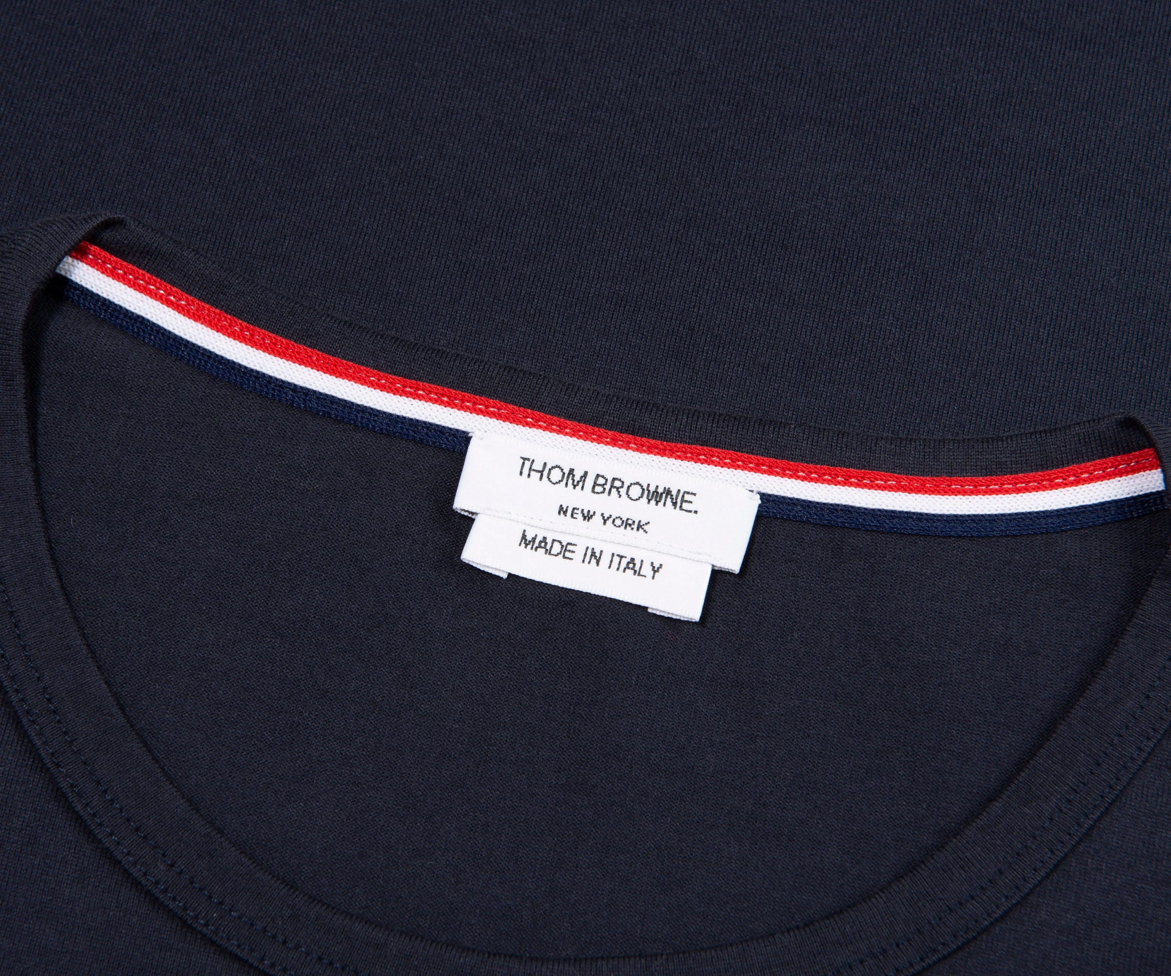Navy shirt with a visible label on a dark background