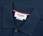 Navy polo shirt collar with a Thom Browne label