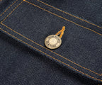 Close-up of a denim fabric with a brand label on a dark blue background