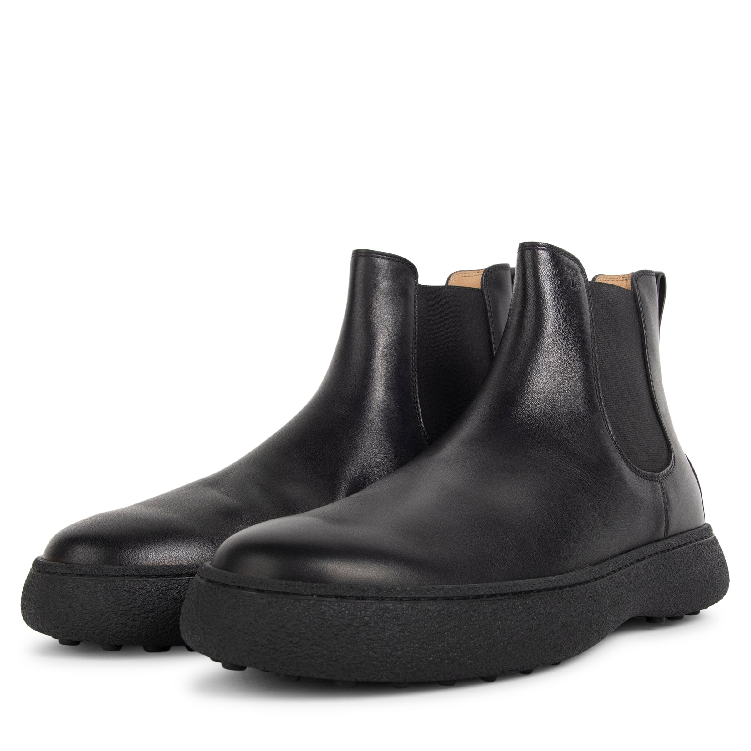 Pair of black leather Chelsea boots on a white background