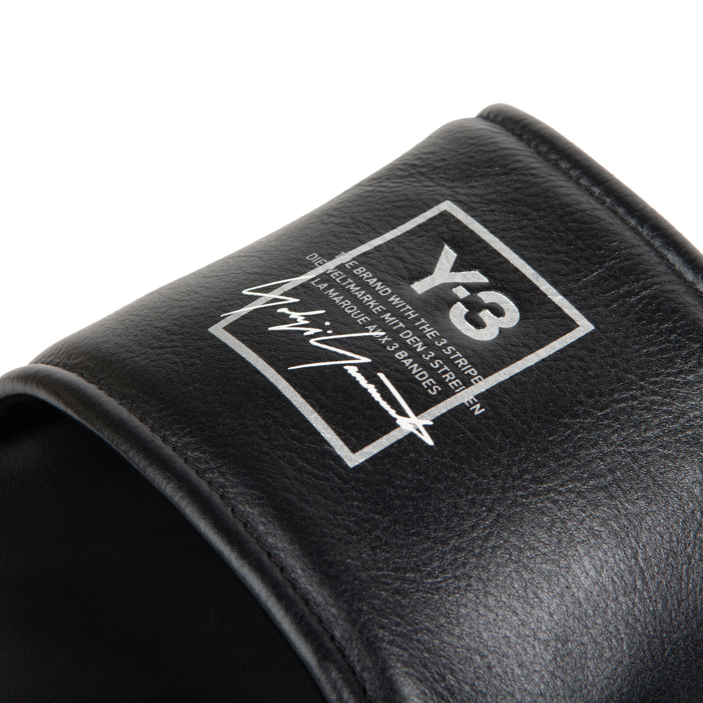 Black sandal with a logo on a white background