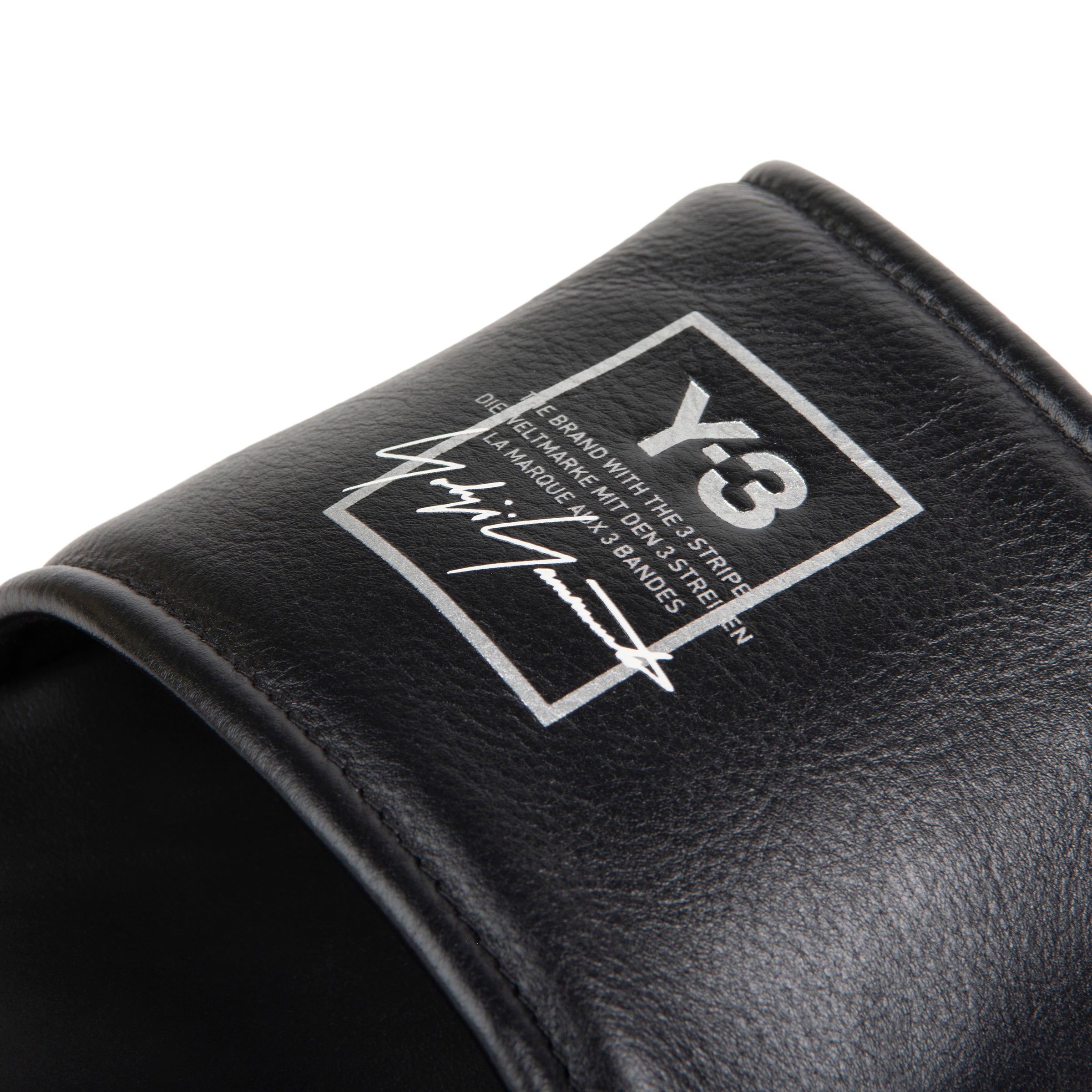 Black sandal with a logo on a white background