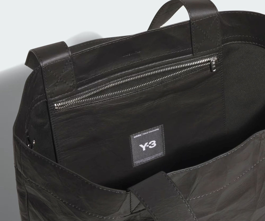 Black bag with a visible Y-3 logo on a light gray background