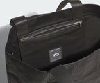 Black bag with a visible Y-3 logo on a light gray background