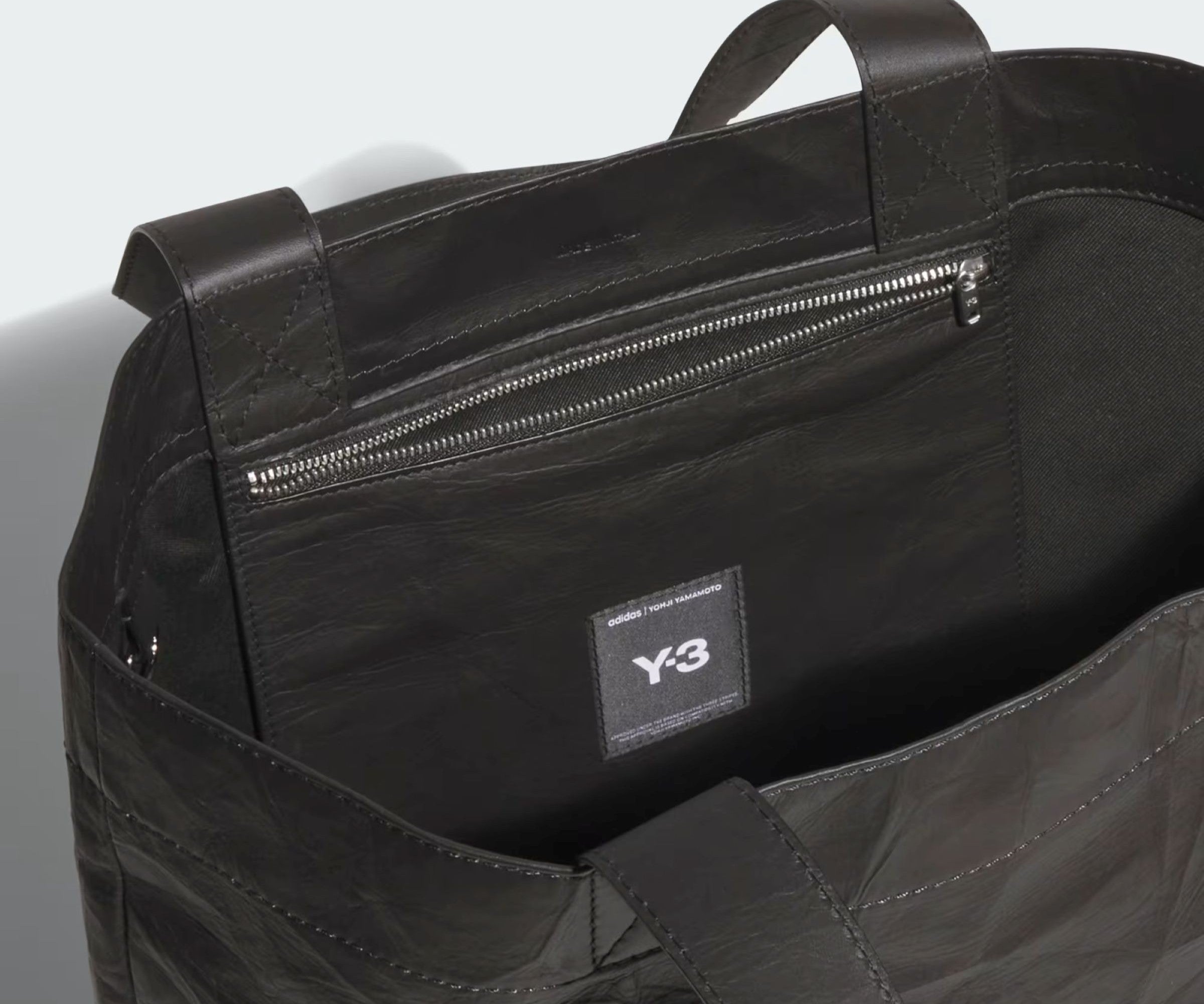 Black bag with a visible Y-3 logo on a light gray background