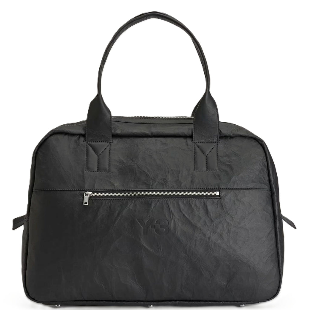 Black textured travel bag with a zipper on a white background