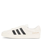 White sneaker with black stripes on a white background