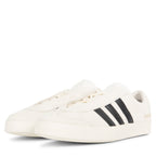 White sneakers with black stripes on a white background