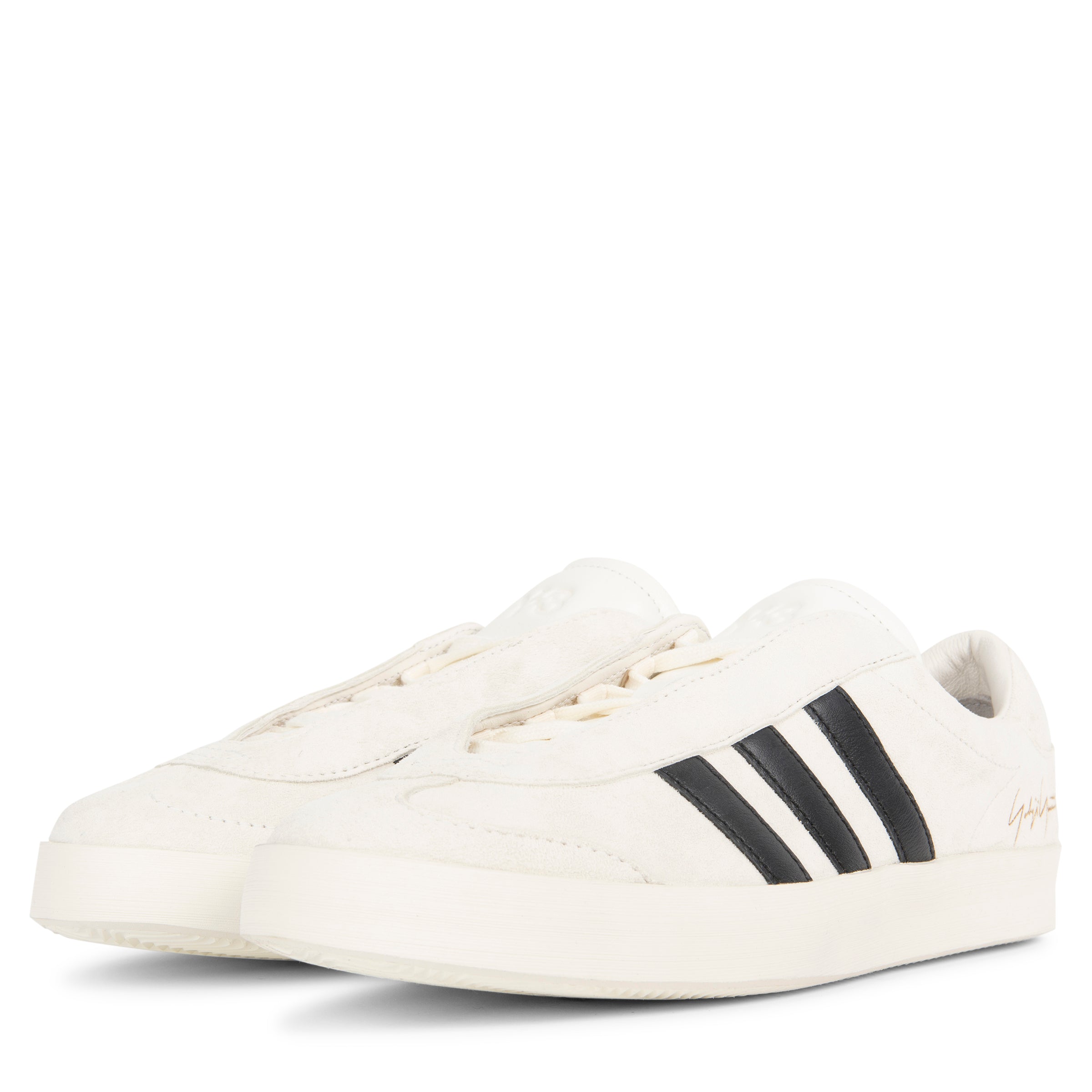 White sneakers with black stripes on a white background