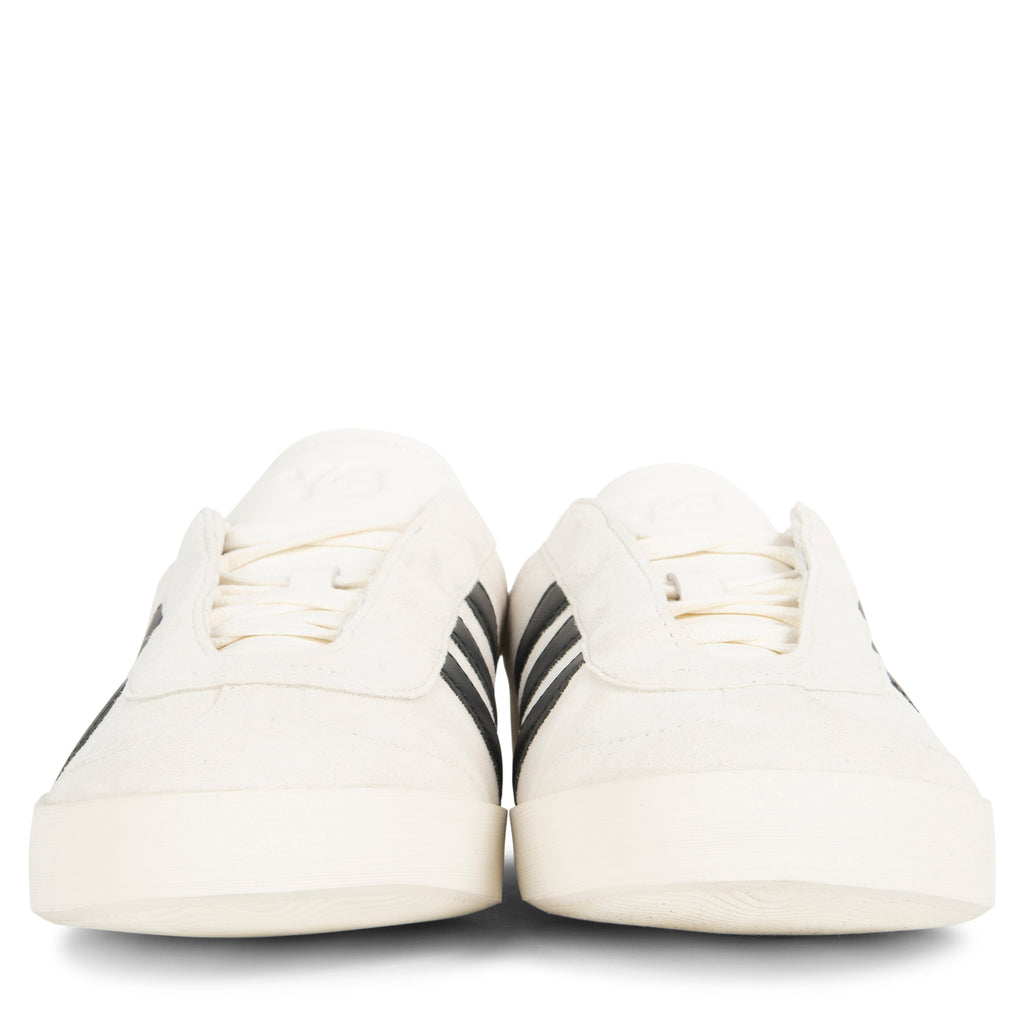 White sneakers with black stripes on a white background