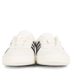 White sneakers with black stripes on a white background