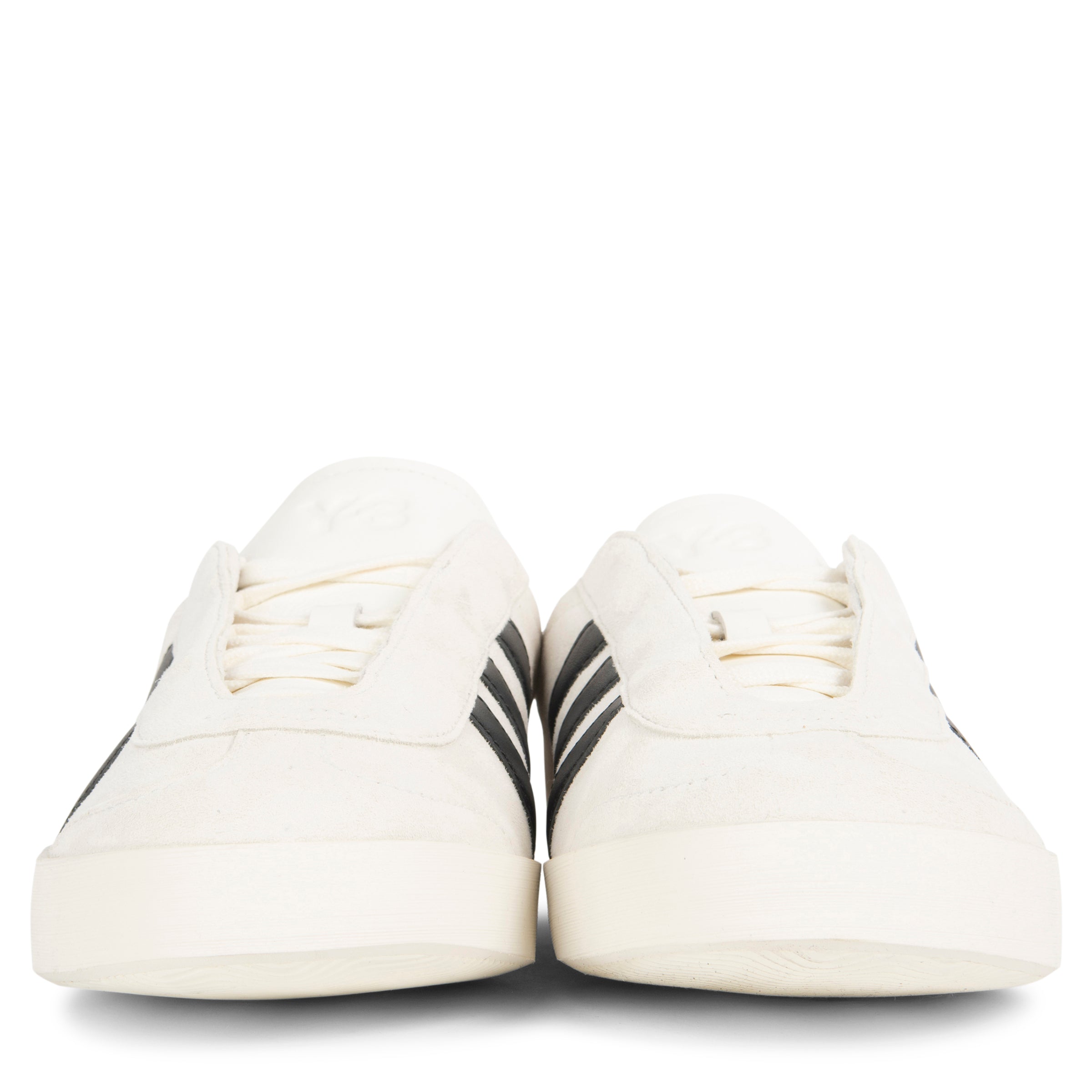 White sneakers with black stripes on a white background